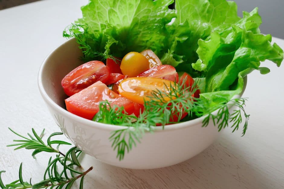 A large bowl of green salad with tomatoes and cucumber, scanned in a calorie scanner app for calories and macros